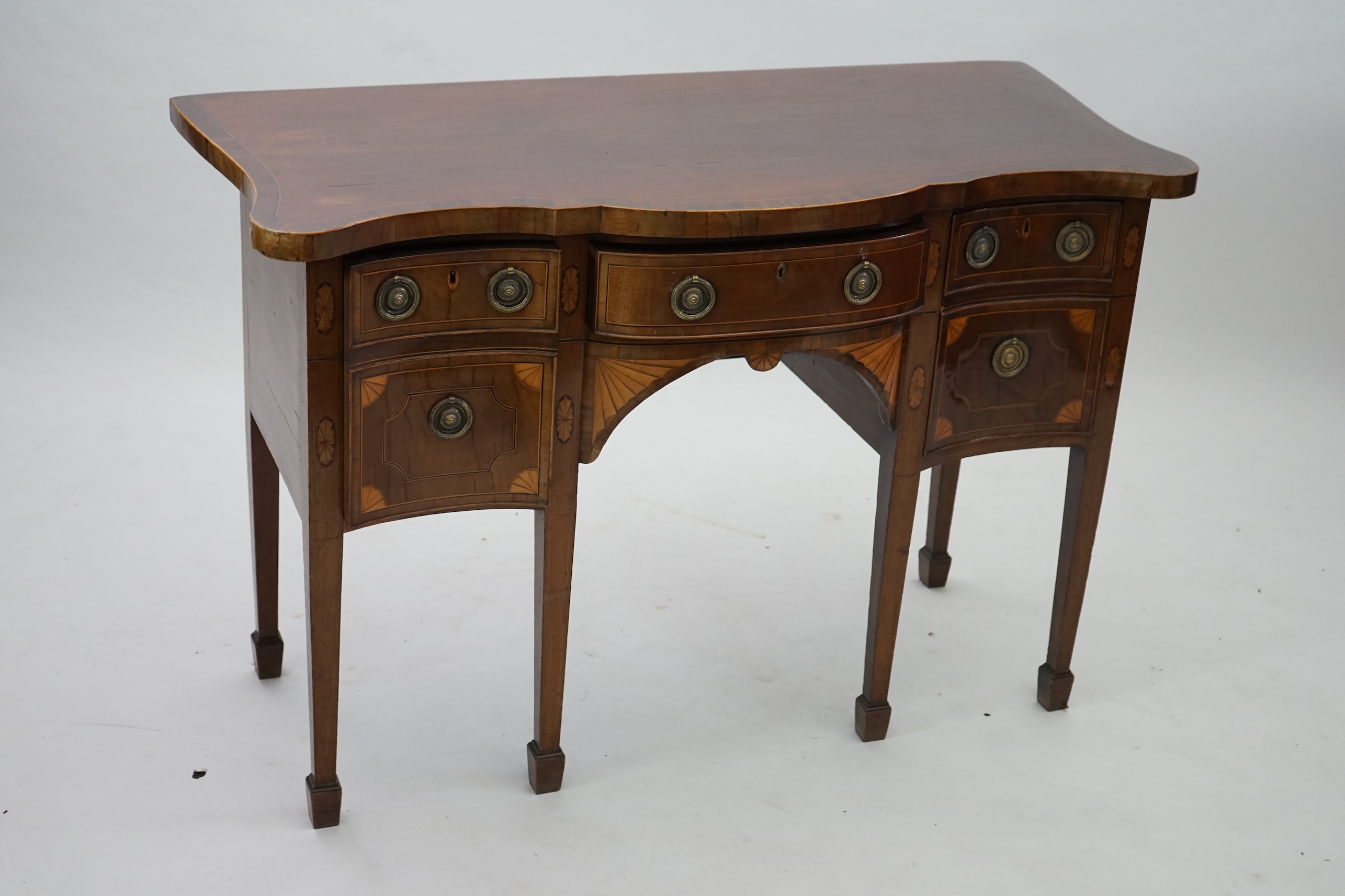 A George III inlaid mahogany serpentine sideboard